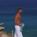 Athletic man wearing green stretch slim fit chino shorts for summer 2025