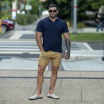 Stylish Summer Outfits for men who lift Navy Polo with Brown Chino Shorts