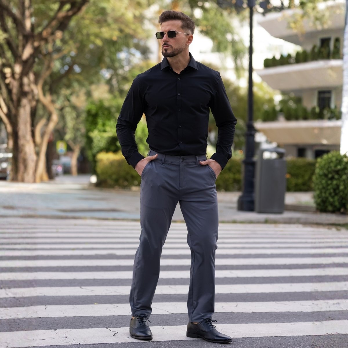 Man wearing Kojo Fit slim fit stretch dress pants in Graphite Dark Grey
