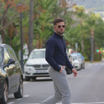 Man wearing Kojo fit Navy muscle fit dress shirt with grey formal pants with stretch comfort