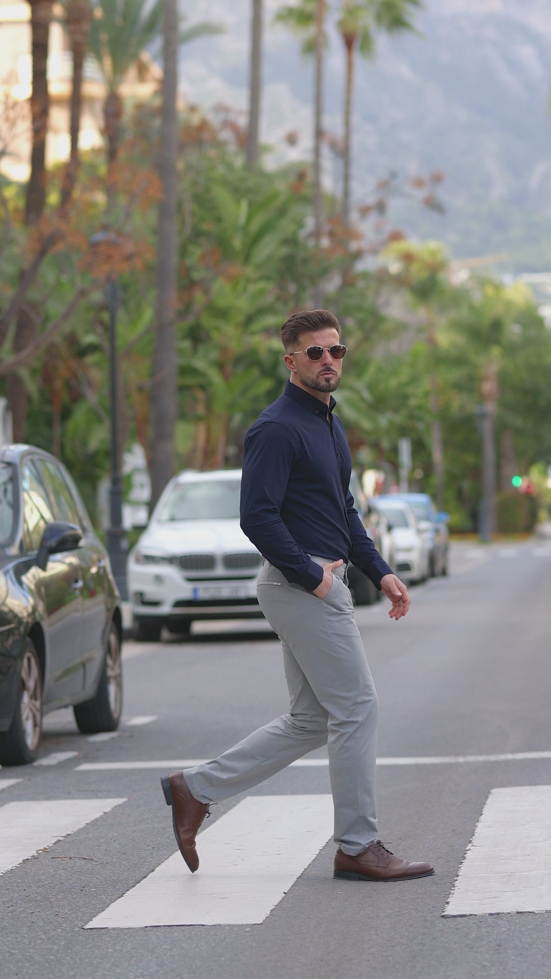 Man wearing Kojo fit Navy muscle fit dress shirt with grey formal pants with stretch comfort