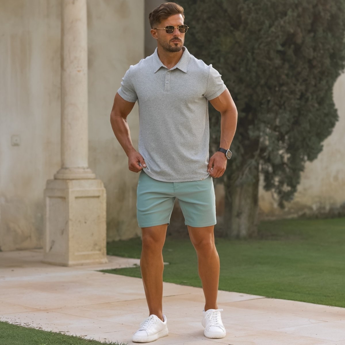 Man wearing athletic fit gray polo shirt with pastel green slim fit chino shorts