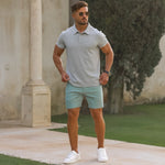 Man wearing athletic fit gray polo shirt with pastel green slim fit chino shorts