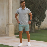 Man wearing athletic fit gray polo shirt with pastel green slim fit chino shorts
