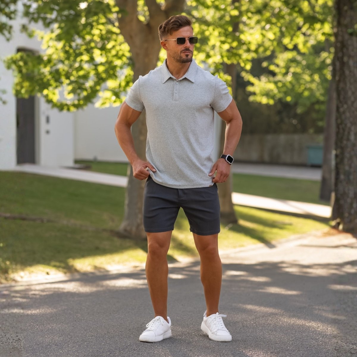 Mean wearing grey athletic fit polo with styish dark grey chino shorts with slim fit by Kojo Fit