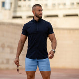 Man wearing fitted chino shorts in sky blue with muscle fit shirt outfit